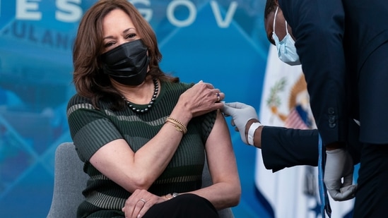 Administering White House medical staff wipes the arm of Vice President Kamala Harris as she is prepared to receive her Moderna Covid-19 vaccine booster shot at the Eisenhower Executive Office Building on the White House complex, in Washington, on October 30, 2021. (AP Photo/Manuel Balce Ceneta)(AP)