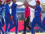 Afghanistan's Naveen-ul-Haq, fourth left, is congratulated by teammates after taking the wicket of Namibia's Michael Van Lingen during the Cricket Twenty20 World Cup match between Afghanistan and Namibia in Abu Dhabi, UAE, Sunday, Oct. 31, 2021. (AP Photo/Kamran Jebreili)(AP)