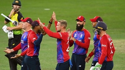 England players celebrate a wicket during the ICC Men's Twenty20 World Cup 2021 cricket match between England and Australia, at Dubai International Cricket Stadium, in Dubai on Saturday. (ANI Photo) (ANI ) England players celebrate a wicket during the ICC Men's Twenty20 World Cup 2021 cricket match between England and Australia, at Dubai International Cricket Stadium, in Dubai on Saturday. (ANI Photo) (ANI )