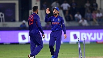 Indian cricket captain Virat Kohli, right, speaks with teammate India's Varun Chakravarthy after an unsuccessful attempt to run-out Pakistan's Mohammad Rizwan during the Cricket Twenty20 World Cup match between India and Pakistan in Dubai, UAE (AP) Indian cricket captain Virat Kohli, right, speaks with teammate India's Varun Chakravarthy after an unsuccessful attempt to run-out Pakistan's Mohammad Rizwan during the Cricket Twenty20 World Cup match between India and Pakistan in Dubai, UAE (AP)