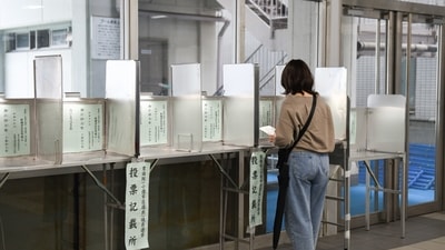 A voter casts a ballot at a polling location in the Shinjuku District of Tokyo, Japan, on Sunday. (Bloomberg) A voter casts a ballot at a polling location in the Shinjuku District of Tokyo, Japan, on Sunday. (Bloomberg)