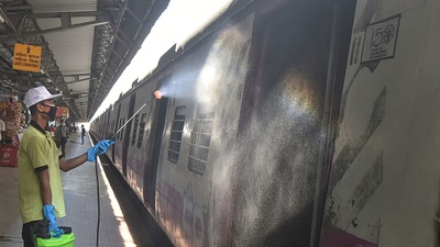 A worker sanitises a compartment of a local train at Sealdah Railway station in Kolkata on the eve of the resumption of its services with 50 per cent capacity. (PTI) A worker sanitises a compartment of a local train at Sealdah Railway station in Kolkata on the eve of the resumption of its services with 50 per cent capacity. (PTI)