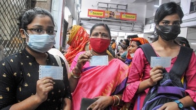 Passengers show their tickets to board local train after the resumption of local train services in West Bengal. (PTI) Passengers show their tickets to board local train after the resumption of local train services in West Bengal. (PTI)
