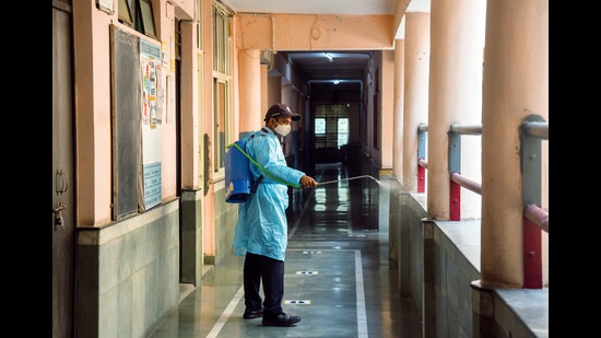 As Delhi gears up to reopen schools from November 1st, a staff members sanitises the corridors of the Vidya Bal Bhawan Senior Secondary School, in New Delhi on Sunday. (ANI) As Delhi gears up to reopen schools from November 1st, a staff members sanitises the corridors of the Vidya Bal Bhawan Senior Secondary School, in New Delhi on Sunday. (ANI)