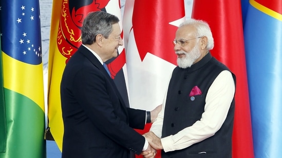 Prime Minister Narendra Modi exchanges greetings with Italian Prime Minister Mario Draghi during the G-20 Summit, at the Rome Convention Centre, in Rome.(ANI)