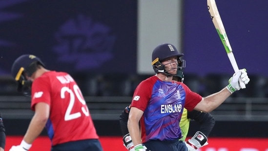 England's Jos Buttler,right celebrates his 50 runs during the Cricket Twenty20 World Cup match between Australia and England in Dubai, UAE, Saturday, Oct. 30, 2021. (AP Photo/Aijaz Rahi) (AP)