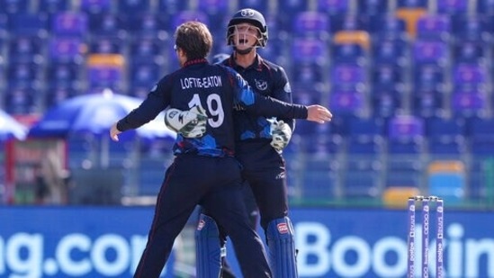 Namibia's wicketkeeper Zane Green, right, congratulates teammate Nicole Loftie-Eaton after taking the wicket of Afghanistan's Rahmanullah Gurbaz, centre, during the Cricket Twenty20 World Cup match between Afghanistan and Namibia in Abu Dhabi, UAE, Sunday, Oct. 31, 2021. (AP Photo/Kamran Jebreili)(AP)