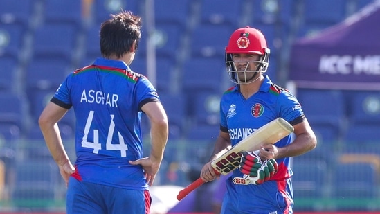 Afghanistan's Najibullah Zadran, right, talks with teammate Asghar Afghan during the Cricket Twenty20 World Cup match between Afghanistan and Namibia in Abu Dhabi, UAE, Sunday, Oct. 31, 2021. (AP Photo/Kamran Jebreili)(AP)