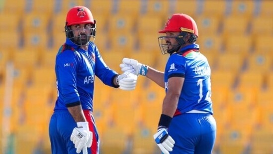 Afghanistan's Gulbadin Naib, right, and teammate Mohammad Nabi gesture during the Cricket Twenty20 World Cup match between Afghanistan and Namibia in Abu Dhabi, UAE, Sunday, Oct. 31, 2021. (AP Photo/Kamran Jebreili)(AP)