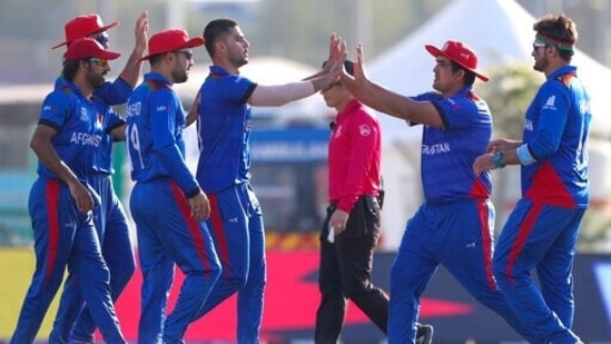 Afghanistan's Naveen-ul-Haq, fourth left, is congratulated by teammates after taking the wicket of Namibia's Michael Van Lingen during the Cricket Twenty20 World Cup match between Afghanistan and Namibia in Abu Dhabi, UAE, Sunday, Oct. 31, 2021. (AP Photo/Kamran Jebreili)(AP)