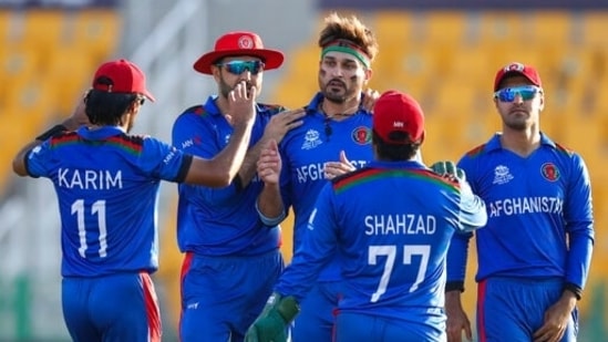 Afghanistan's Hamid Hassan, centre, is congratulated by teammates after dismissing Namibia's JJ Smit during the Cricket Twenty20 World Cup match between Afghanistan and Namibia in Abu Dhabi, UAE, Sunday, Oct. 31, 2021. (AP Photo/Kamran Jebreili)(AP)