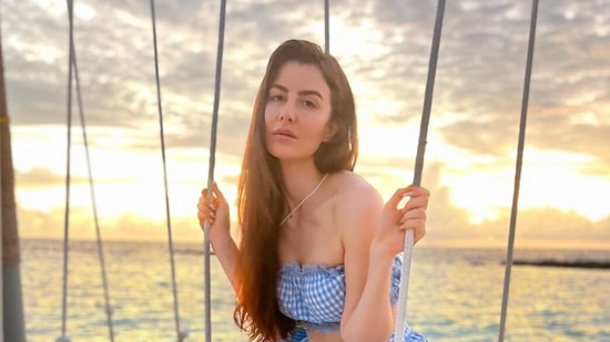 Giorgia chilling on a swing in the ocean.
