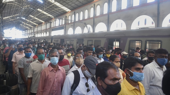 Passengers come out of the platform of Sealkdah Railway station in Kolkata after a staff special arrives ahead of the resumption of local train services.(PTI)