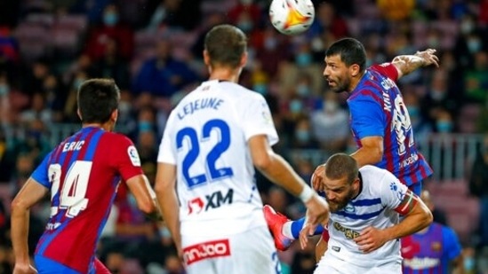 Barcelona's Sergio Aguero, top right, heads the ball during the La Liga soccer match between Barcelona and Alaves at the Camp Nou stadium in Barcelona, Spain Saturday, Oct. 30, 2021. (AP Photo/Joan Monfort) (AP)