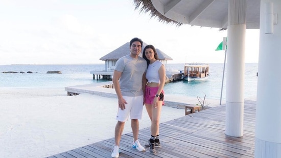 Arbaaz and Giorgia posing for a picture by the ocean.