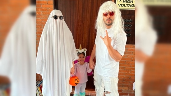 Soha Ali Khan turned into a ghost by covering her entire self with a white cloth with two cutouts in the eye area. She added the black shades to complete her ghost look.(Instagram/@sakpataudi)