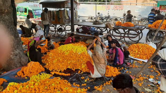 People engaged in making marigold strings. (HT Photo)