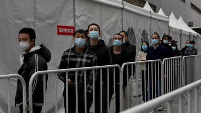 People queue for swab test for Covid-19 coronavirus in Beijing on Monday. (AFP) People queue for swab test for Covid-19 coronavirus in Beijing on Monday. (AFP)