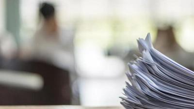 Exam answer sheet or application paper blurry view on table in examination room with blur education background of school university students taking exam test writing answer in seat row with stress (REPRESENTATIVE PHOTO)