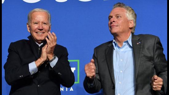 US President Joe Biden (left) and Virginia Democratic gubernatorial candidate Terry McAuliffe gesture during a campaign event at Virginia Highlands Park in Arlington, Virginia. At the rally, Biden attacked his predecessor Donald Trump at least 27 times. (AFP)
