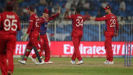 England's Chris Jordan, second right, celebrates the dismissal of Sri Lanka's Avishka Fernando during the Cricket Twenty20 World Cup match between England and Sri Lanka in Sharjah, UAE, Monday, Nov. 1, 2021.&nbsp;(AP)