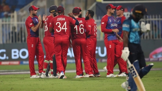 England's Adil Rashid, without cap, celebrates the dismissal of Sri Lanka's Kusal Perera, right, during the Cricket Twenty20 World Cup match between England and Sri Lanka in Sharjah, UAE, Monday, Nov. 1, 2021.&nbsp;(AP)