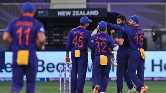 India's players celebrate the wicket of New Zealand's Martin Guptill during the Cricket Twenty20 World Cup match between New Zealand and India in Dubai, UAE.(AP)