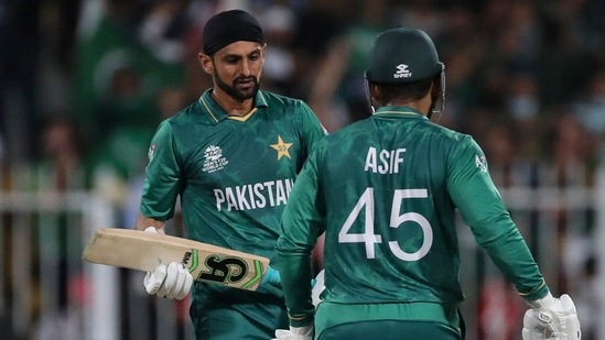 Pakistan's Shoaib Malik, left, celebrates with Asif Ali after hitting a boundary during the Cricket Twenty20 World Cup match between New Zealand and Pakistan in Sharjah, UAE. (AP)
