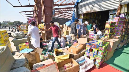 Ludhiana residents at a firecracker market near Grain Market, Jalandhar Bypass, in Ludhiana on Monday. The ban on normal crackers in Punjab is being violated with impunity. (Gurpreet Singh/HT)