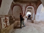 European tourists, escorted by security personnel, visit the old town of Ghadames, a desert oasis some 650 kilometres (400 miles) southwest of the Libyan capital Tripoli, during an organised tour in the town. (Photo by Mahmud TURKIA / AFP) European tourists, escorted by security personnel, visit the old town of Ghadames, a desert oasis some 650 kilometres (400 miles) southwest of the Libyan capital Tripoli, during an organised tour in the town. (Photo by Mahmud TURKIA / AFP)