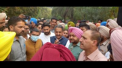 Punjab cabinet minister Vijay Inder Singla talking to farmers in the Sangrur district administration complex on Tuesday.