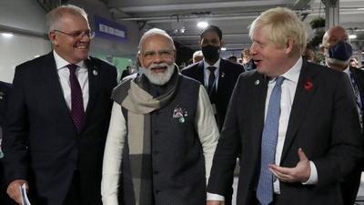 PM Narendra Modi with his British counterpart Boris Johnson and Australia’s PM Scott Morrison at the UN Climate Change Conference (COP26) in Glasgow on Tuesday. Modi launched ‘Infrastructure for Resilient Island States’ for most vulnerable countries. (REUTERS) PM Narendra Modi with his British counterpart Boris Johnson and Australia’s PM Scott Morrison at the UN Climate Change Conference (COP26) in Glasgow on Tuesday. Modi launched ‘Infrastructure for Resilient Island States’ for most vulnerable countries. (REUTERS)
