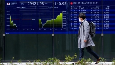 A man looks at screens showing Japan's Nikkei 225 index at a securities firm in Tokyo. (Representational image) (AP Photo) A man looks at screens showing Japan's Nikkei 225 index at a securities firm in Tokyo. (Representational image) (AP Photo)