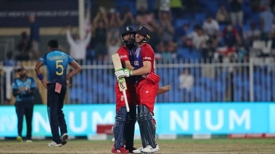 England's Moeen Ali, left, hugs teammate Jos Buttler for scoring a century during the Cricket Twenty20 World Cup match between England and Sri Lanka in Sharjah, UAE, Monday, Nov. 1, 2021. (AP Photo/Aijaz Rahi) (AP) England's Moeen Ali, left, hugs teammate Jos Buttler for scoring a century during the Cricket Twenty20 World Cup match between England and Sri Lanka in Sharjah, UAE, Monday, Nov. 1, 2021. (AP Photo/Aijaz Rahi) (AP)
