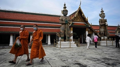 Buddhist monks walk inside the Grand Palace, a day after Thailand welcomed vaccinated traveller to enter the country without the two-week quarantine. (AFP) Buddhist monks walk inside the Grand Palace, a day after Thailand welcomed vaccinated traveller to enter the country without the two-week quarantine. (AFP)