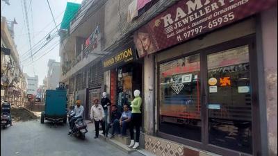 Shopkeepers sitting idle outside their shops on the occasion of Dhanteras in Deep Nagar of Ludhiana on Tuesday. (HT Photo)