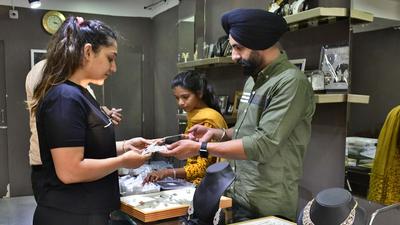 A woman buying jewellery at a shop on Dhanteras in Ludhiana on Tuesday. The gold rate on Dhanteras was recorded at ₹49,400 per 10 gram and silver price was ₹67,000 per kg. (Harsimar Pal Singh/HT) A woman buying jewellery at a shop on Dhanteras in Ludhiana on Tuesday. The gold rate on Dhanteras was recorded at ₹49,400 per 10 gram and silver price was ₹67,000 per kg. (Harsimar Pal Singh/HT)