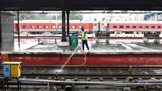 An Indian Railways employee washes tracks at a station in Amritsar. Indian Railways has made it easier now to get permits for filming on its premises. (AFP)