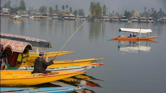 A boatman on a shikara at Dal Lake in Srinagar on Sunday. The Jammu and Kashmir (J&K) home department on Monday gave the go-ahead for the formation of the State Investigation Agency (SIA). (PTI)