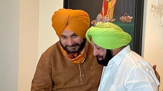 File photo of Captain Amarinder Singh with Navjot Singh Sidhu.(HT Photo)