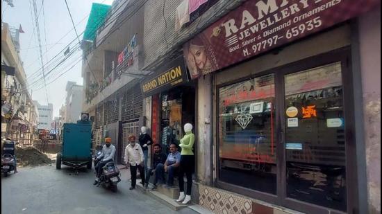 Shopkeepers sitting idle outside their shops on the occasion of Dhanteras in Deep Nagar of Ludhiana on Tuesday. (HT Photo)