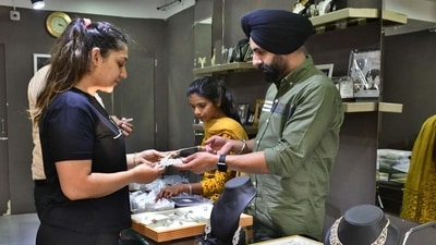 A woman buying jewellery at a shop on Dhanteras in Ludhiana on Tuesday. (Harsimar Pal Singh/HT Photo)