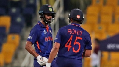 India's Rohit Sharma, right, celebrates with batting partner KL Rahul after hitting a six during the Cricket Twenty20 World Cup match between India and Afghanistan in Abu Dhabi, UAE, Wednesday, Nov. 3, 2021. (AP Photo/Aijaz Rahi) (AP)