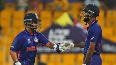 India's Rishabh Pant, left, and Hardik Pandya celebrate scoring runs during the Cricket Twenty20 World Cup match between India and Afghanistan in Abu Dhabi, UAE, Wednesday, Nov. 3, 2021. (AP Photo/Aijaz Rahi) (AP)
