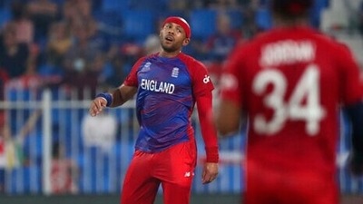 England's Tymal Mills reacts after Sri Lanka's captain Dasun Shanaka hit a boundary on his delivery during the Cricket Twenty20 World Cup match between England and Sri Lanka in Sharjah, UAE, Monday, Nov. 1, 2021. (AP)