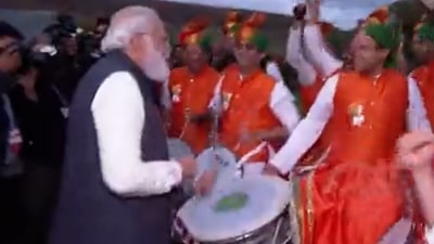 Watch: PM Modi plays drums in meeting with Indian community in Glasgow (Video grab) Watch: PM Modi plays drums in meeting with Indian community in Glasgow (Video grab)