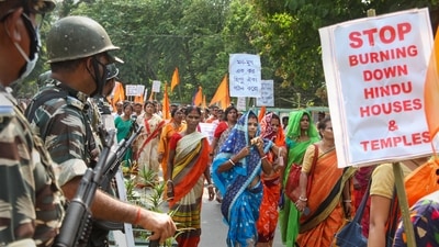 Protestors hold placards and raise slogans during a protest against the alleged attacks on Hindus in Bangladesh, near Bangladesh High Commission in Agartala (PTI) Protestors hold placards and raise slogans during a protest against the alleged attacks on Hindus in Bangladesh, near Bangladesh High Commission in Agartala (PTI)