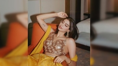 Khushi Kapoor flaunted her tattoo as she posed in the gorgeous yellow lehenga on the couch. (Instagram/@khushi05k)