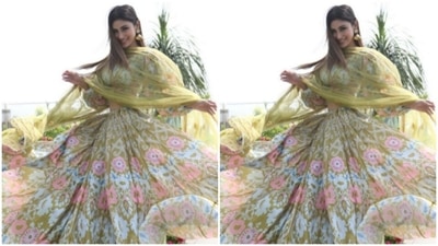 Designed by fashion designer house Idaho, Mouni’s lehenga is teamed with a contrasting green silk dupatta. (Instagram/@imouniroy)
