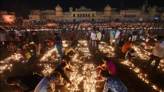 Ayodhya: Devotees light earthen lamps on the bank of Saryu River during Deepotsav celebrations in Ayodhya last year before Diwali. (PTI File Photo)